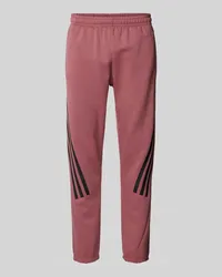 adidas Slim Fit Sweatpants mit labeltypischen Streifen Altrosa