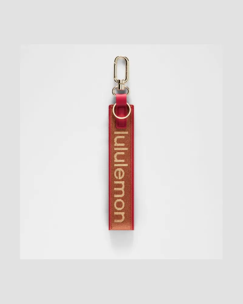 LULULEMON Lunar New Year Never Lost Schlüsselanhänger Metallic Wordmark in Oxford Red/Gold Buff Oxford