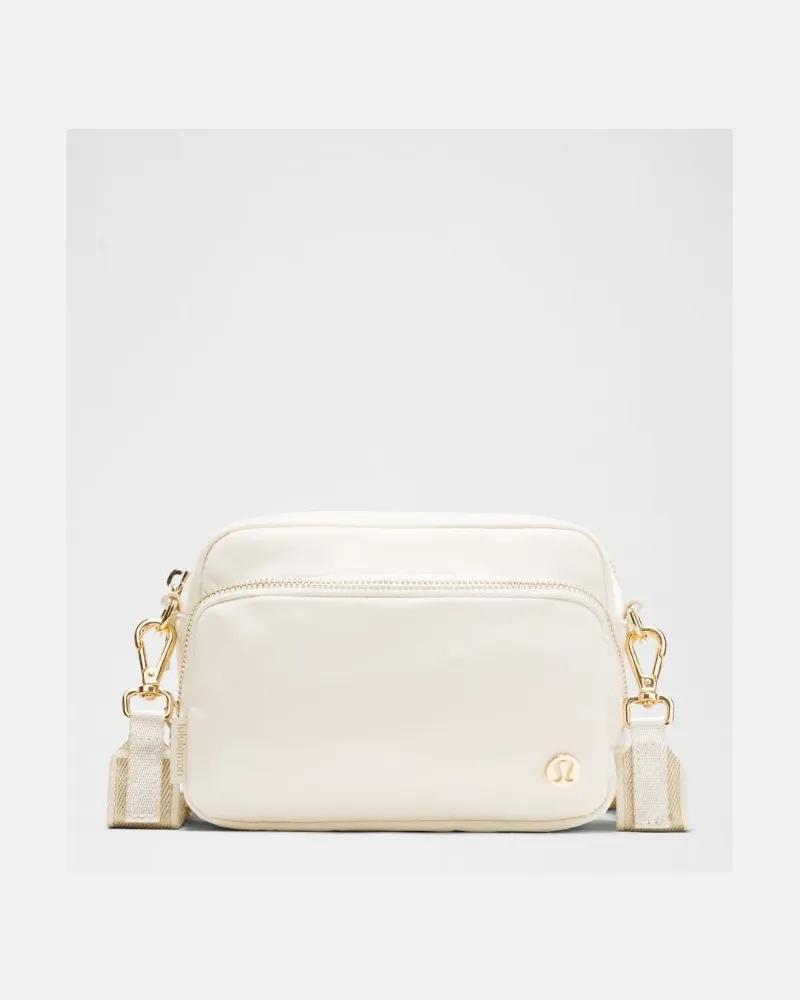 LULULEMON Everywhere Crossbody Bag 2L Metallic Wordmark in Light Ivory/Gold Light
