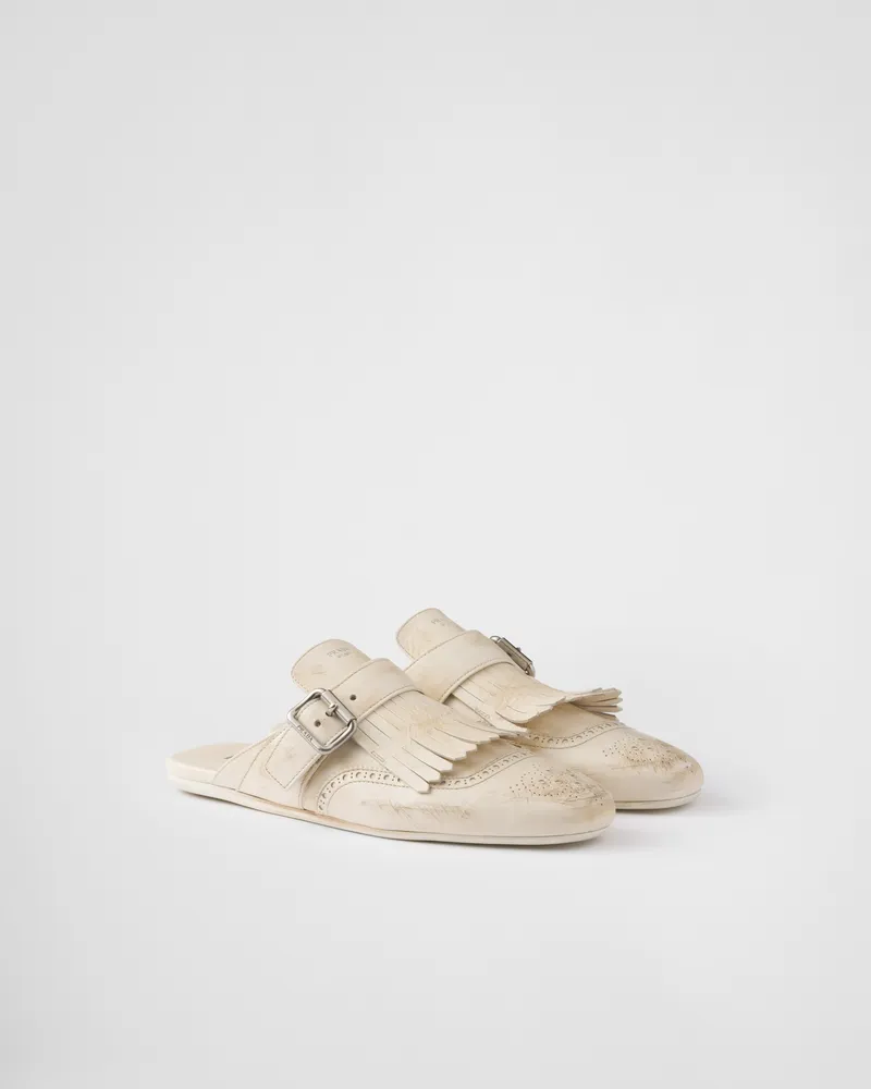 Prada Shuffle Mules aus Leder mit Fransen Kalkweiss