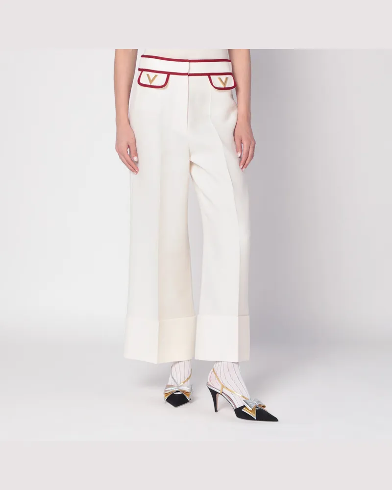 Valentino Garavani Elfenbeinfarbene Hose mit goldenem V Print
