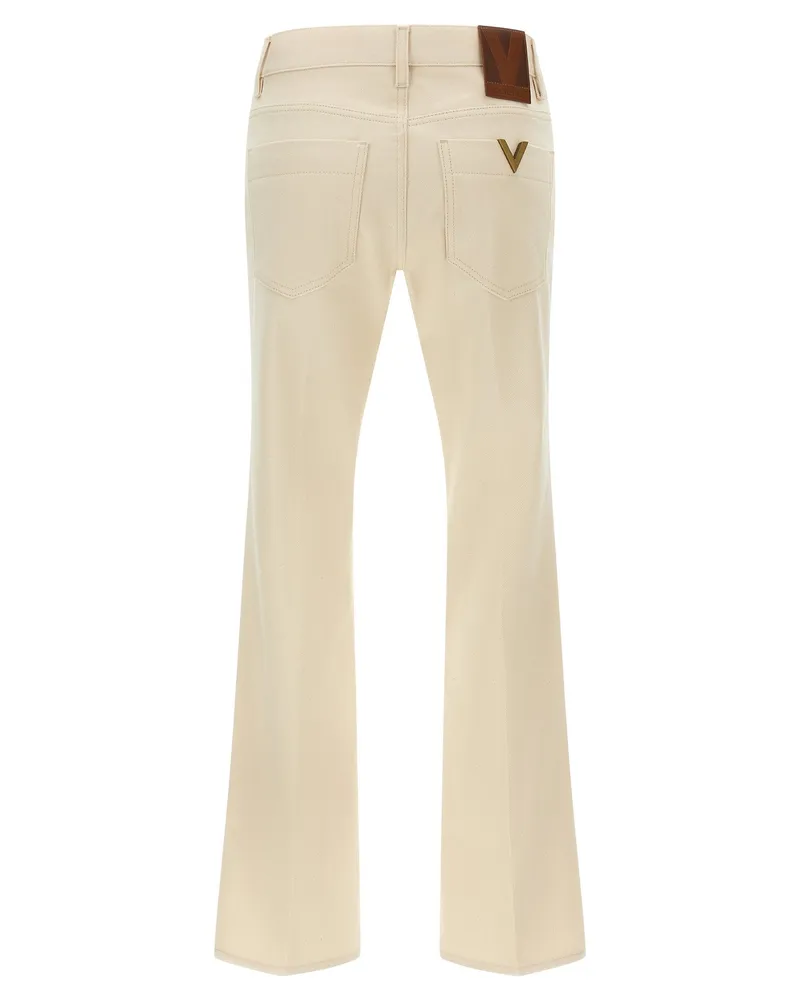 Valentino Garavani Garment-Dyed Flared Jeans — Cream Cream
