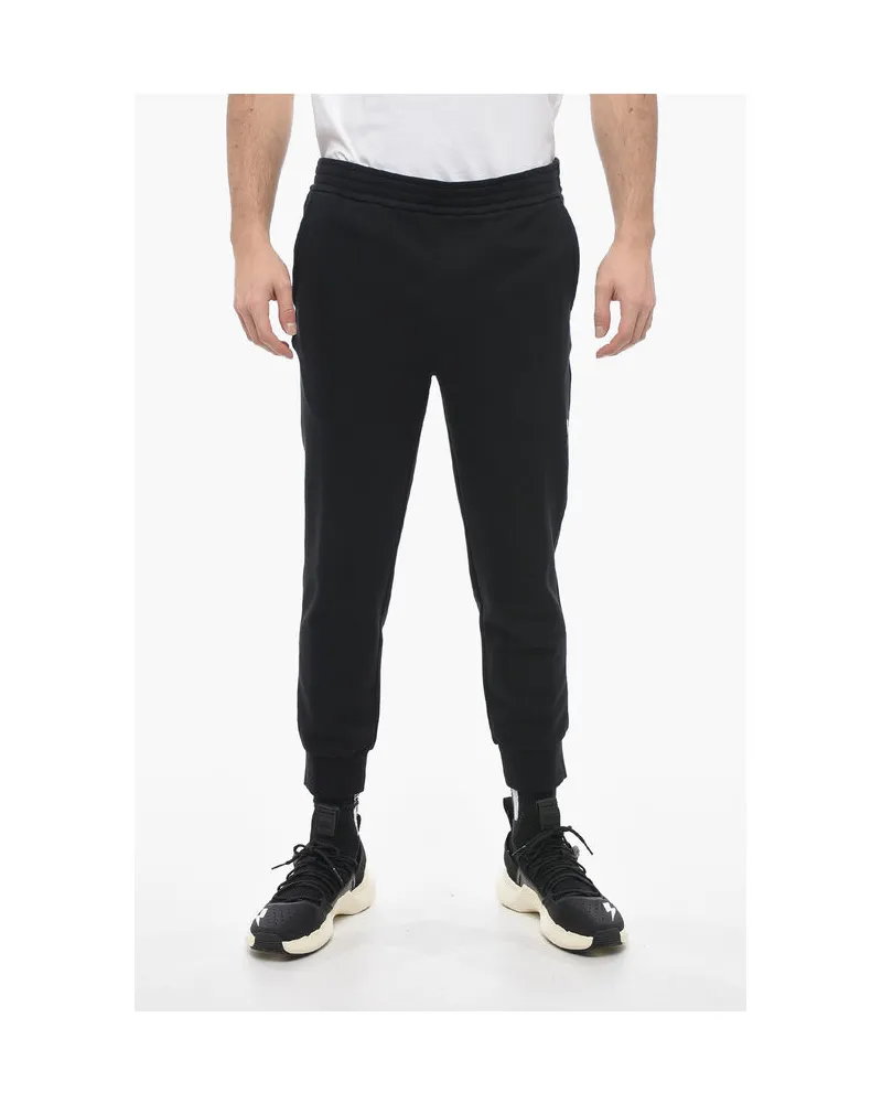 Neil Barrett Skinny Fit Sweatpants aus Baumwolle mit Bündchen in Schwarz Schwarz