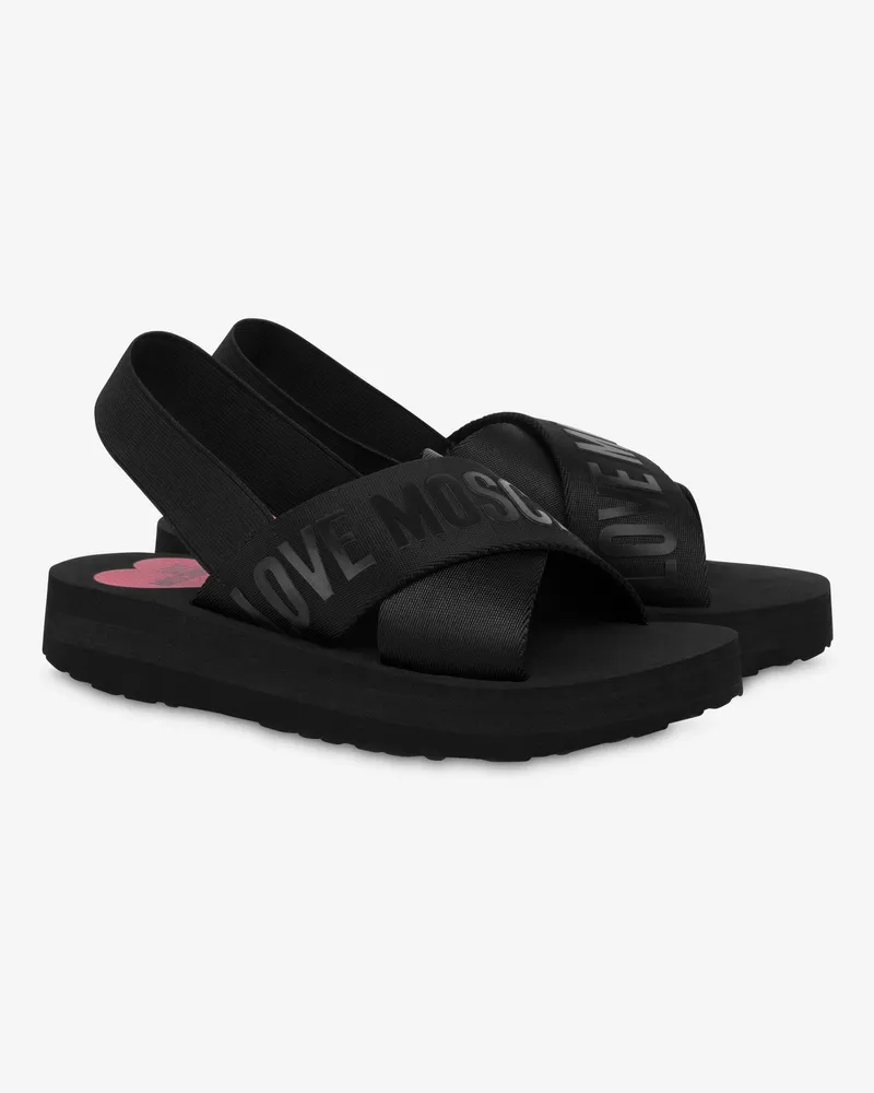 Moschino Überkreuzte Sandalen mit Logobändern - Schwarz Schwarz