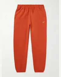 Nike Pantaloni sportivi a gamba affusolata in jersey di misto cotone con logo ricamato Solo Swoosh Rosso