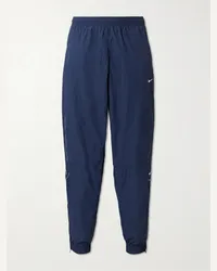 Nike Pantaloni sportivi a gamba affusolata in taffetà con logo ricamato Solo Swoosh Blu