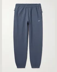 Nike Pantaloni sportivi a gamba affusolata in jersey di misto cotone con logo ricamato Solo Swoosh Blu