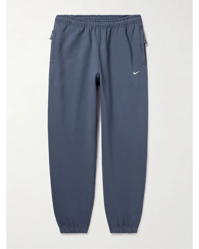 Nike Pantaloni sportivi a gamba affusolata in jersey di misto cotone con logo ricamato Solo Swoosh Blu